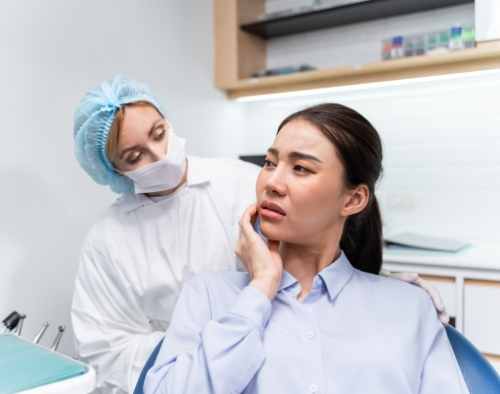 Dentist examining jaw joint and bite alignment at Promenade Village Dental